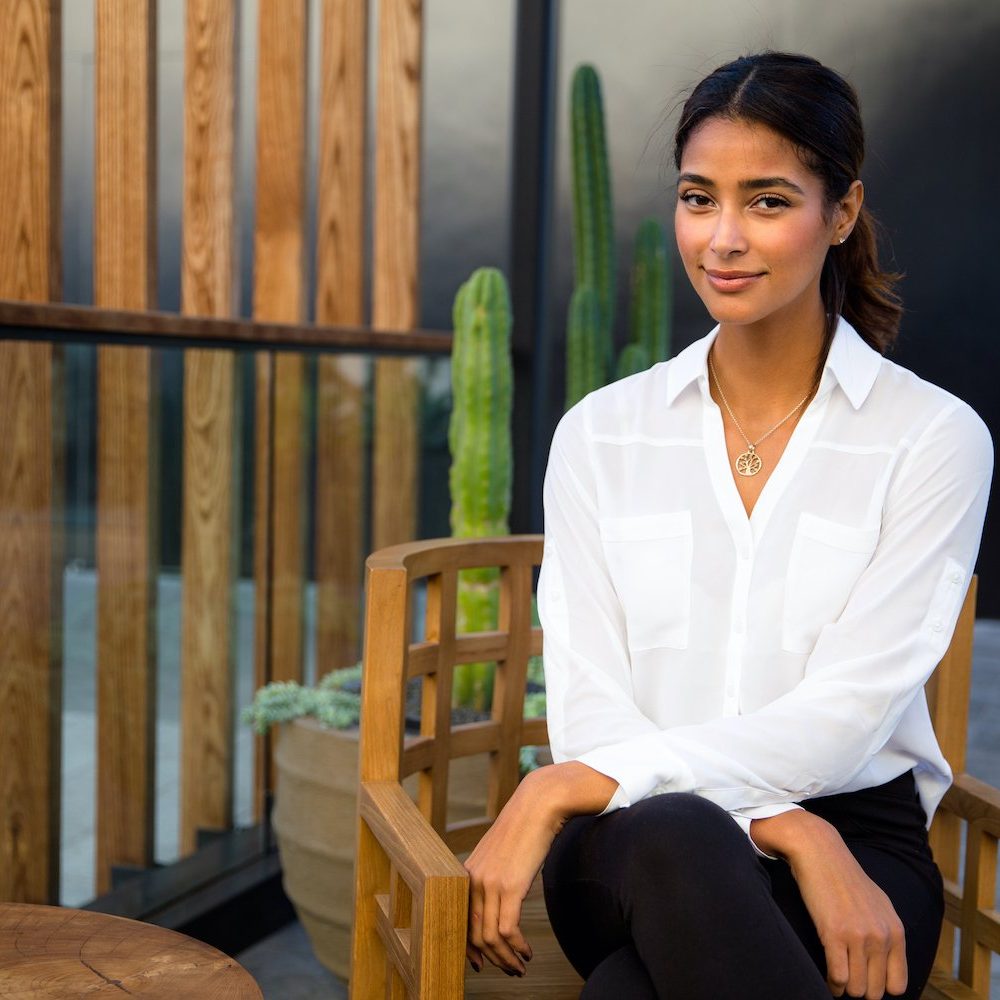 Gorgeous mixed race woman sitting relaxed with peace of mind on home and garden patio